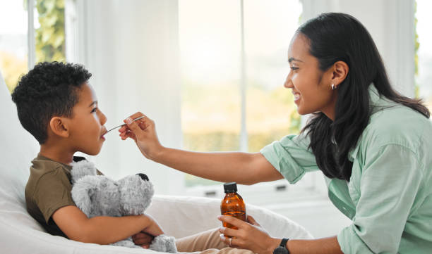 Mom giving son medicine