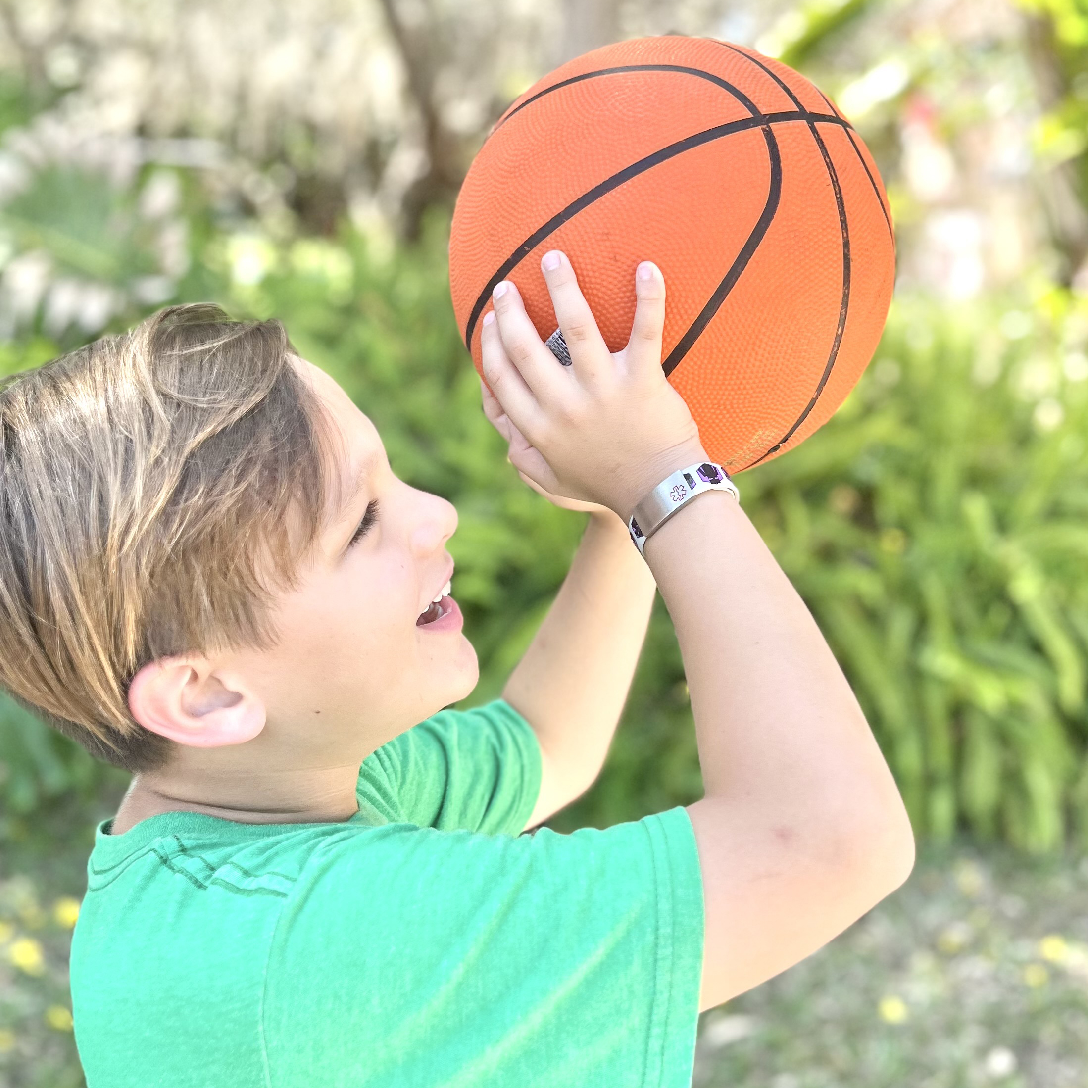 Boy playing baseball with minecraft medical bracelet