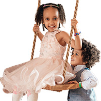 children on swing wearing medical id