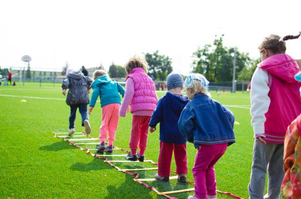 children having recess in a sports field