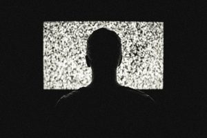 person sitting near television